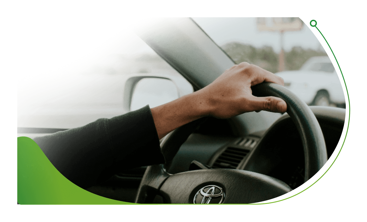 A hand rests on the top of a steering wheel; Marsh Finance at Stoneacre image