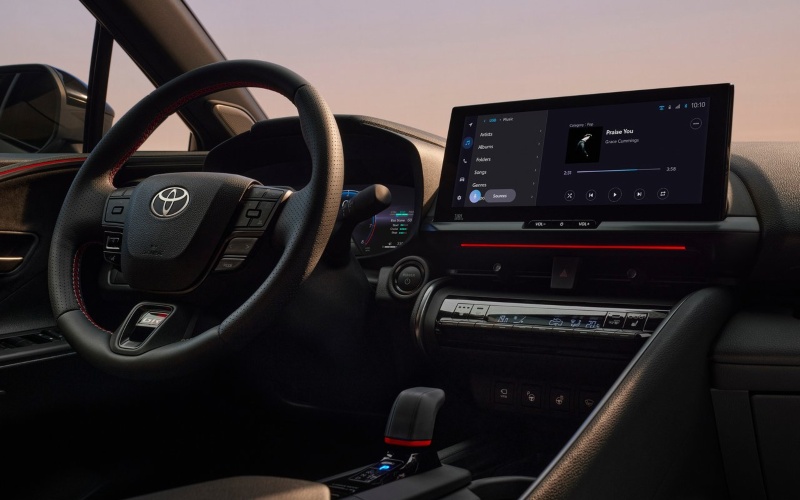 Used Toyota C-HR Hybrid Interior Used Toyota C-HR Hybrid interior with steering wheel controls and a central touchscreen.