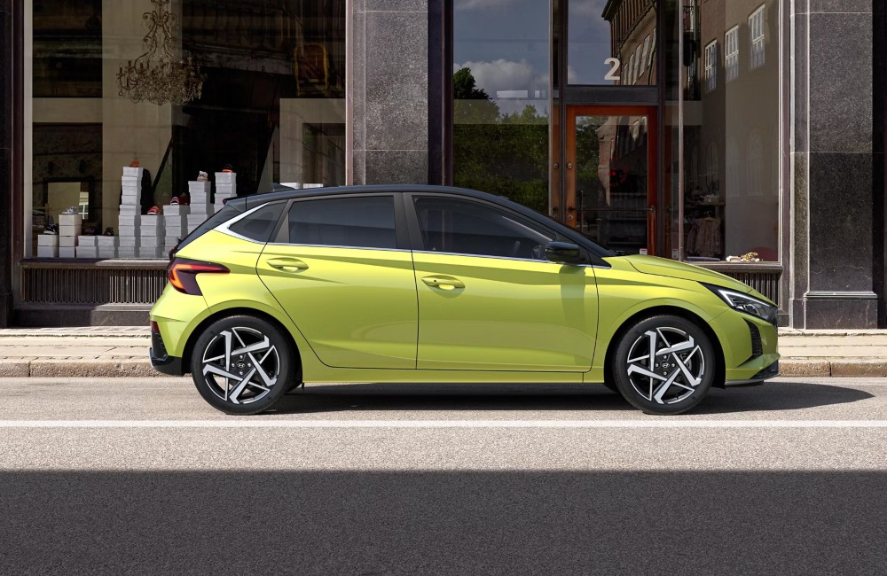 Side profile of a new Hyundai i20, parked on the side of a city street