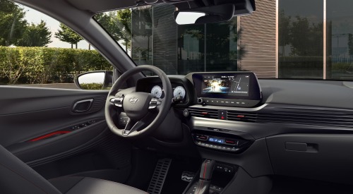 The interior of a new Hyundai i20, showing the drivers seat, steering wheel, and infotainment systems The interior of a new Hyundai i20, showing the drivers seat, steering wheel, and infotainment systems
