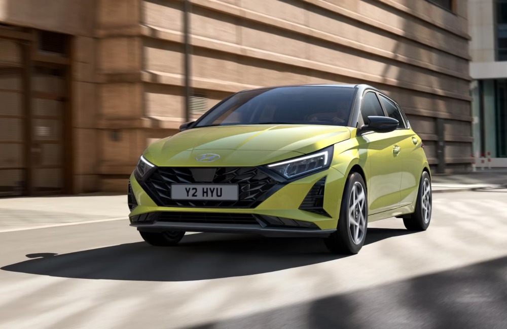 A new Hyundai i20 driving around a city corner at speed A new Hyundai i20 driving around a city corner at speed