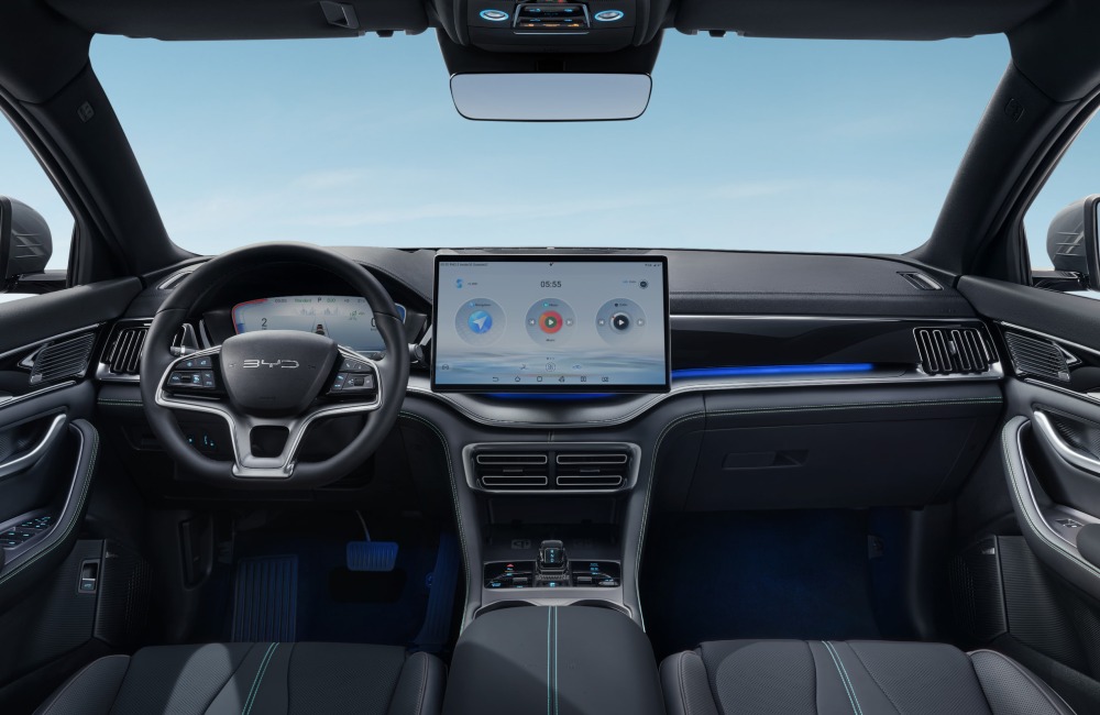 The interior dashboard of a new BYD SEAL U DM-i, showing the central console and infotainment system, steering wheel, ambient lighting, and interior features