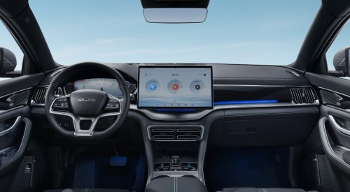 The interior dashboard of a new BYD SEAL U DM-i, showing the central console and infotainment system, steering wheel, ambient lighting, and interior features