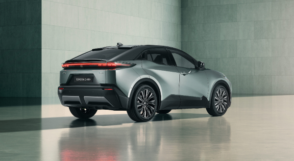 Rear of the New Toyota C-HR+ for sale in Mineral paint with bi-tone black roof, showing LED rear lights and sculpted tailgate.