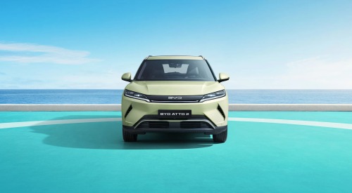 The front of a new BYD ATTO 2, with the backdrop of a calm ocean