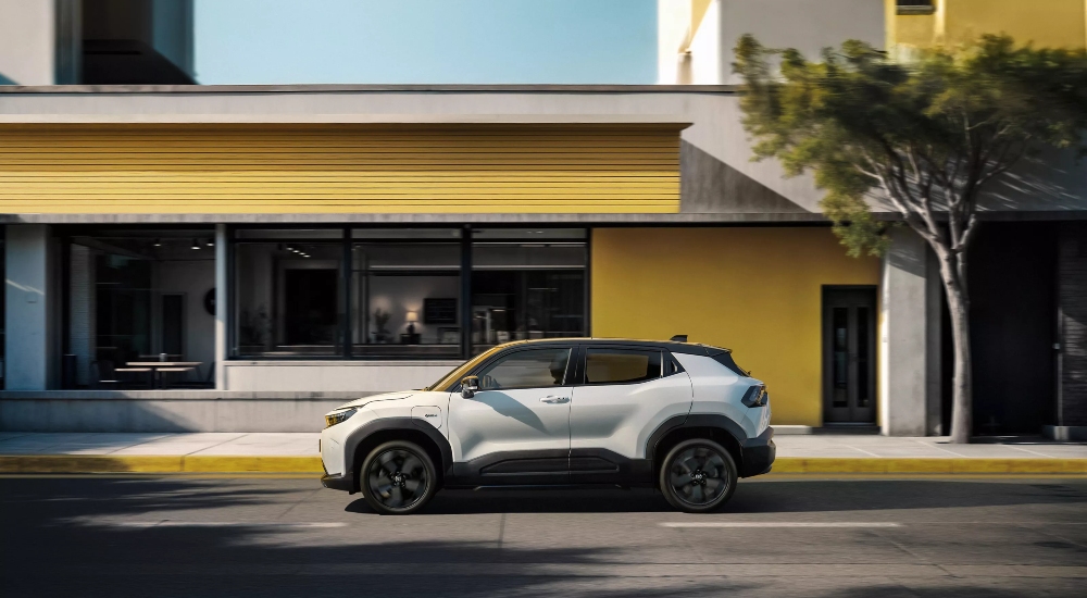 Toyota Urban Cruiser Excel parked alongside a yellow building.