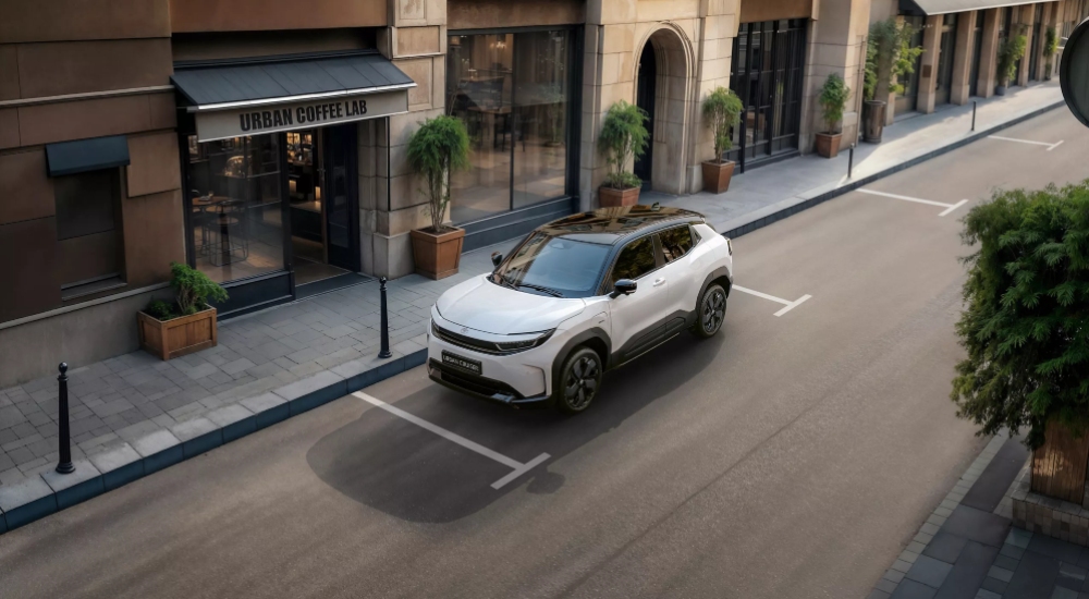 New Toyota Urban Cruiser Excel parked next to a coffee shop in the city.