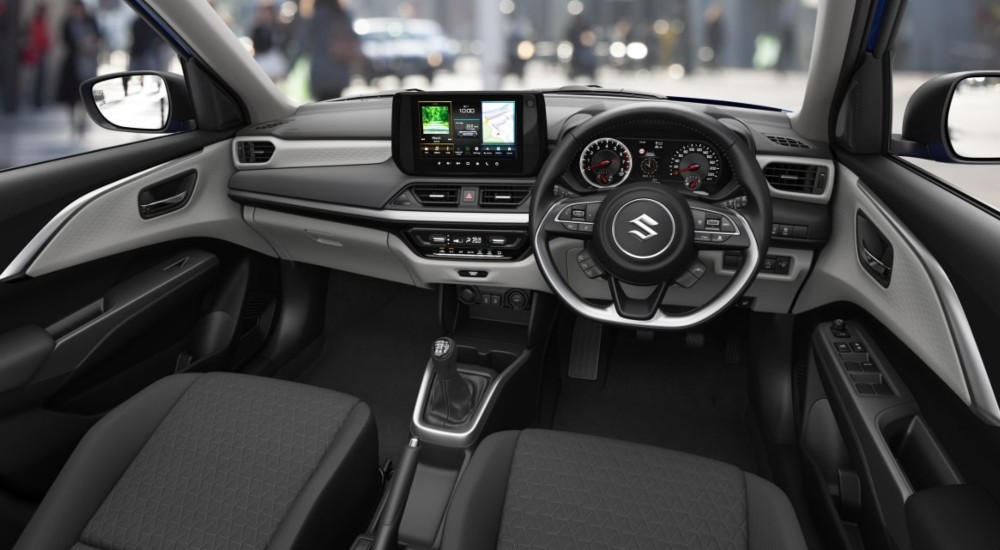 Interior of the new Suzuki Swift with heated seats and a central touchscreen.