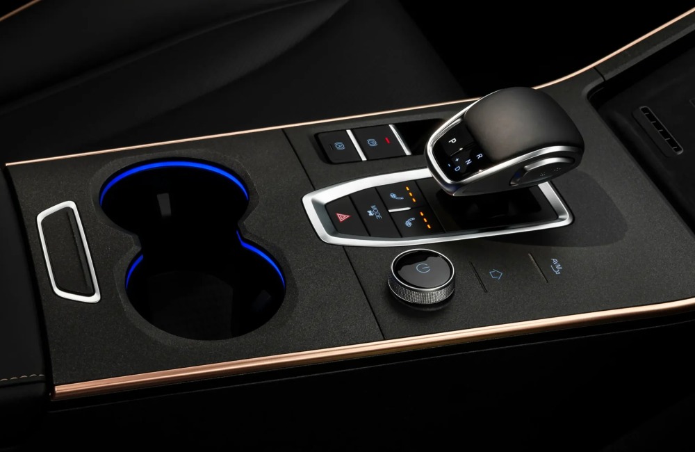 Front centre console of the new OMODA 5, showing cup holders, drive mode changer, central gear shifter, and multiple controls