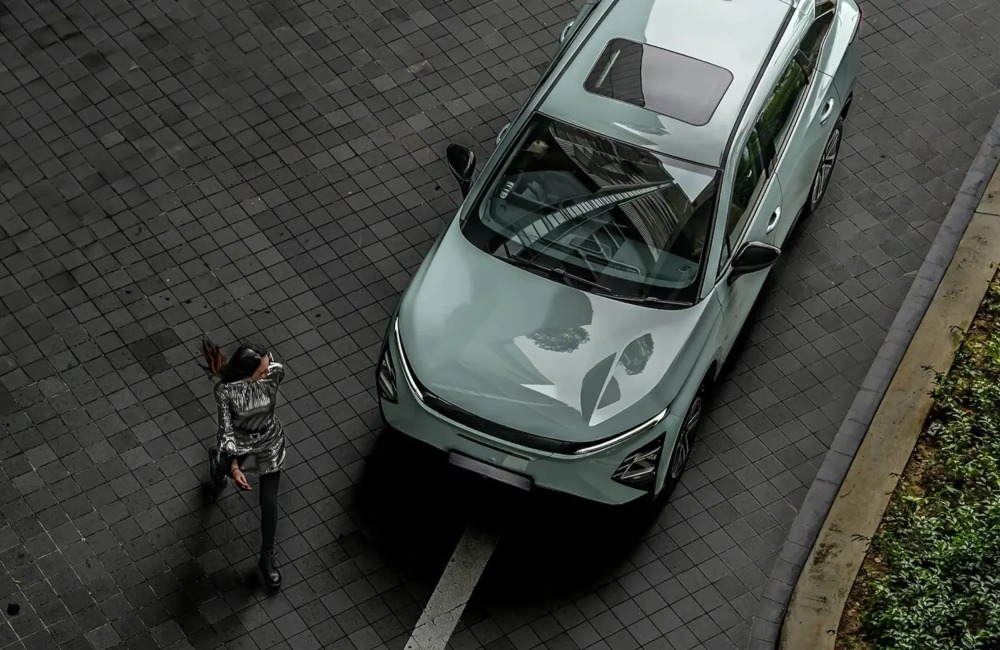 Top down view of a person walking away from a new OMODA E5