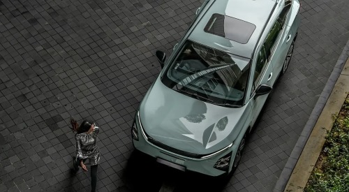 Top down view of a person walking away from a new OMODA E5