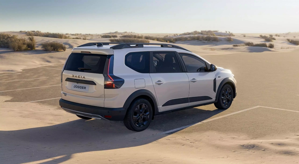New Dacia Jogger Hybrid with a 155hp full hybrid powertrain parked on sand.