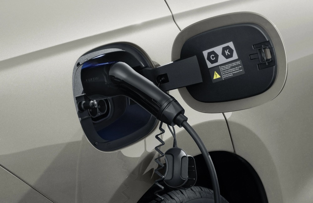 A close up view of a BYD used cars charging point, plugged in.