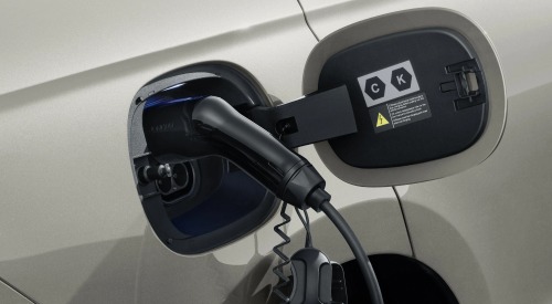 A close up view of a BYD used cars charging point, plugged in.