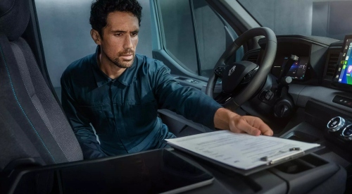 Man using the New Renault Master E-Tech Panel Van cabin as a mobile office; New Renault Master E-Tech Panel Van interior image