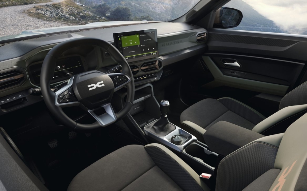 Interior view of a Dacia Duster showing the dashboard, steering wheel, and centre console.