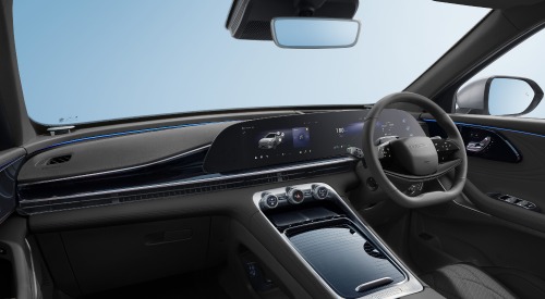 The interior of an OMODA 9 with a focus on the infotainment system, centre console, and driving position.