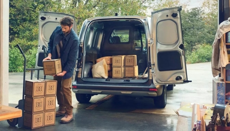 A person loading the rear of a silver Kangoo; Renault Kangoo van second-hand