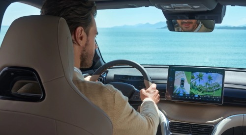 Interior shot of a BYD SEALION 5 DM-i, with focus on the touchscreen infotainment system as the driver uses ADAS to park the car.