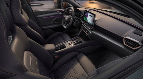 Angled view of entering a CUPRA Leon Estate, showing the comfortable seating, central console, and infotainment system