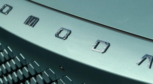 Close-up of the front of an OMODA car, showing off the OMODA badging and hexagonal grille