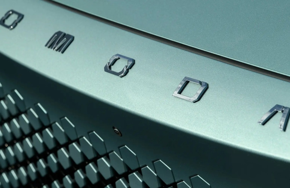 Close-up of the front of an OMODA car, showing off the OMODA badging and hexagonal grille