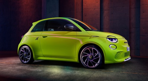 Angled side profile of an Abarth 500e, showing off unique alloy wheels, headlights, and front facade