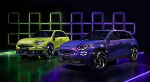 Photoshoot of two Abarth 600e cars, one green and the other purple, with a futuristic background.