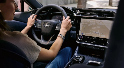 A person driving, using the sat nav of the New All-Electric Lexus RZ; New All-Electric Lexus RZ interior