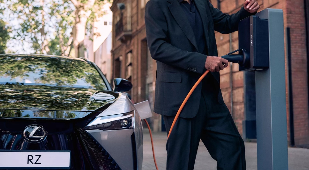 New All-Electric Lexus RZ Charging A person charging the New All-Electric Lexus RZ; New All-Electric Lexus RZ charging