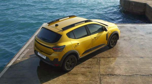 Dacia Sandero Stepway in Amber Yellow with roof bars and black body cladding.