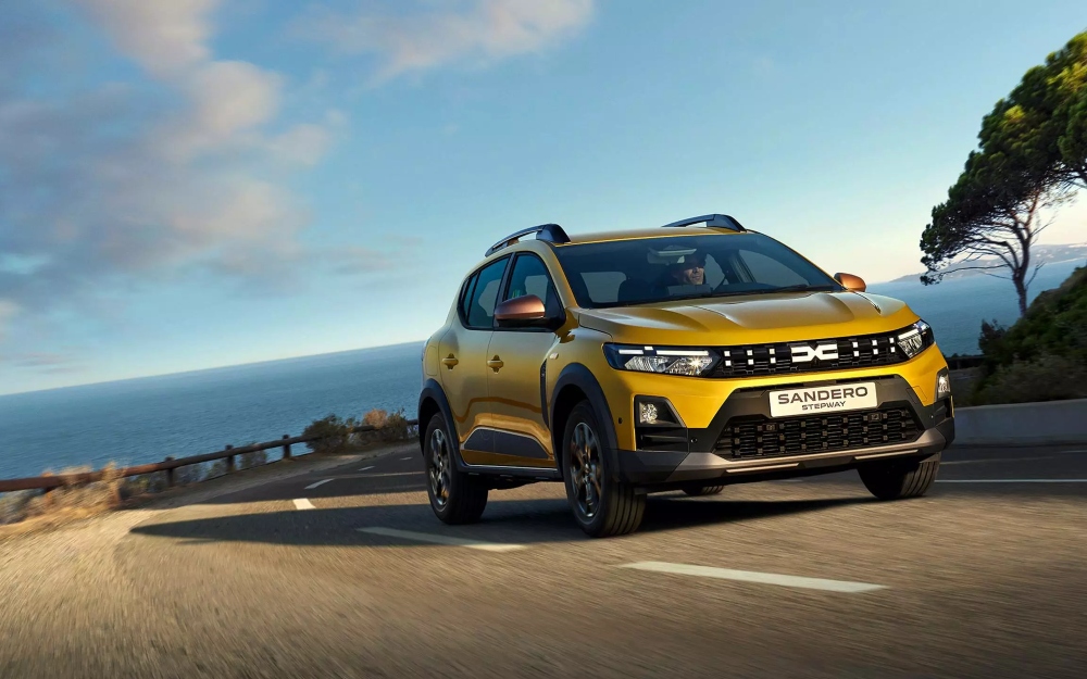 Dacia Sandero Stepway on the Motability Scheme driving along a coastal road.