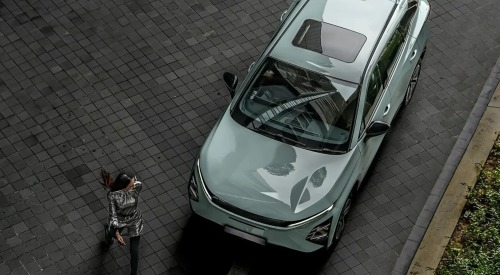 Top down view of a person walking away from an OMODA E5