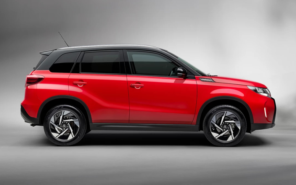 Suzuki Vitara in Bright Red shown in side view against a grey background.