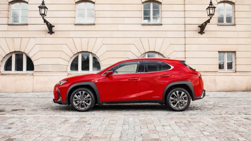 A red Lexus UX on a cobbled street; Lexus pre-owned for sale
