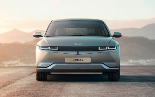 Front view of a Hyundai Ioniq 5 on a road at sunset.