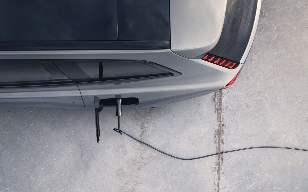 Overhead view of a Volvo EX90 plugged in to charge.