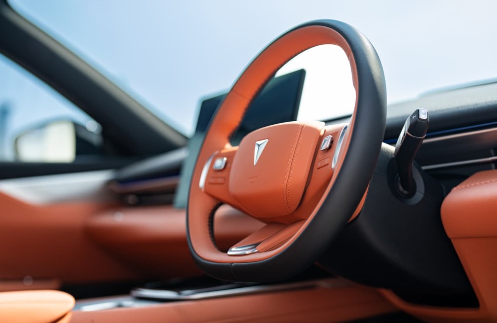 Interior shot of a Changan Deepal S05, showing the orange styling and a close up of the steering wheel