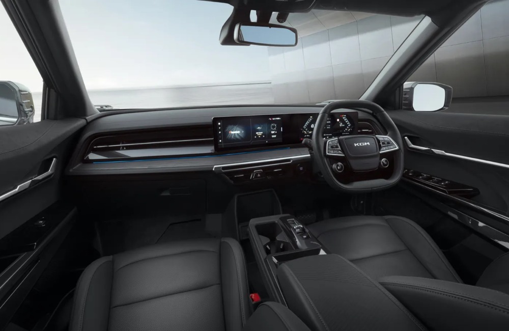 Interior of the KGM Actyon Hybrid, showing off the front two seats, steering wheel, and infotainment system