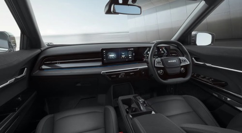 Interior of the KGM Actyon Hybrid, showing off the front two seats, steering wheel, and infotainment system