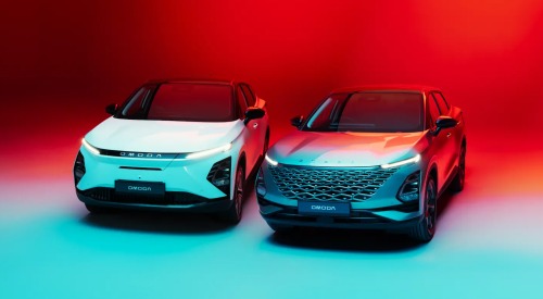 A photoshoot showing off two OMODA cars. The backdrop is red and blue. Both cars are showing off their front design and day time running lights.