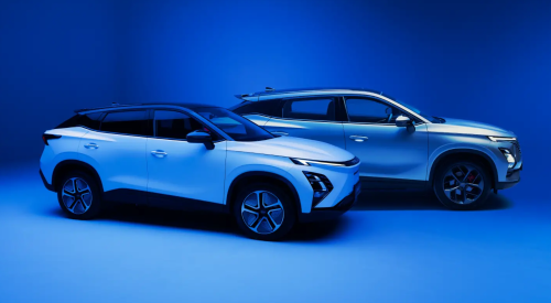 Photoshoot of two OMODA cars. The cars are posing to the right, showing off their side profiles. They are stages on a blue backdrop.