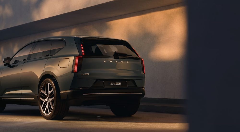 Rear three-quarter view of the Volvo EX60 in Forest Lake showing vertical LED tail lights.