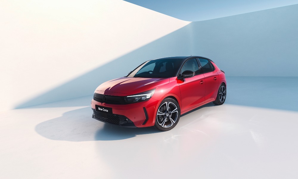 A red Vauxhall Corsa posing at an angle towards the camera in a photoshoot with an all-white backdrop.